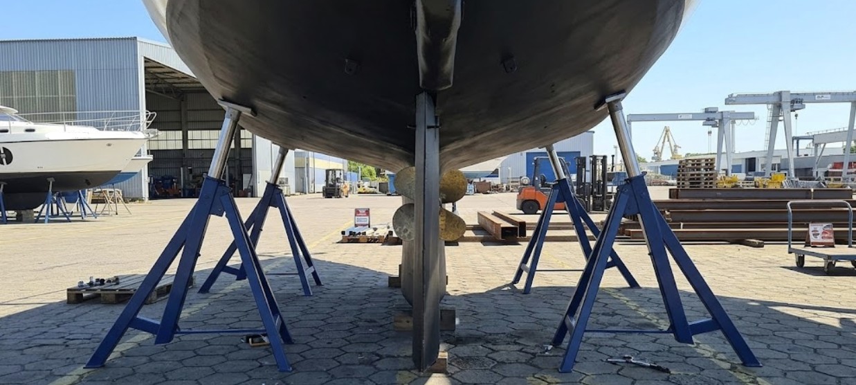 Boat stands supporting yacht hull at a professional boatyard