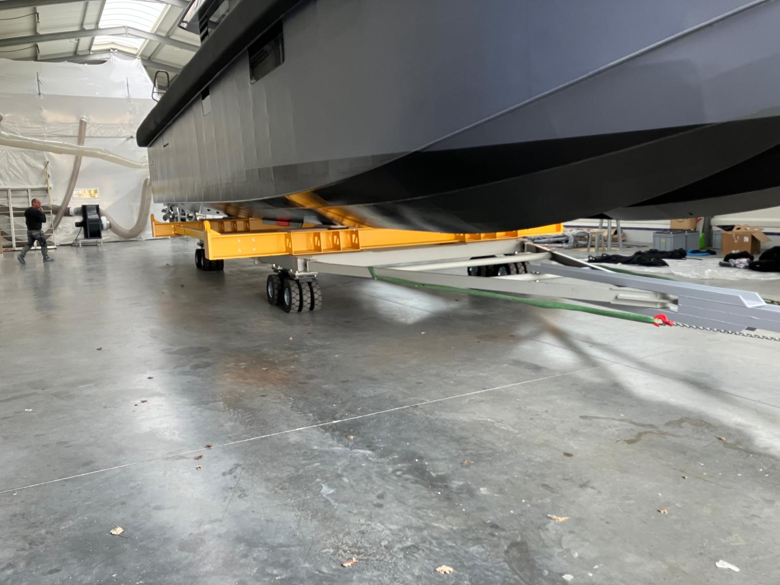 Yacht on transport cradle inside refit hangar