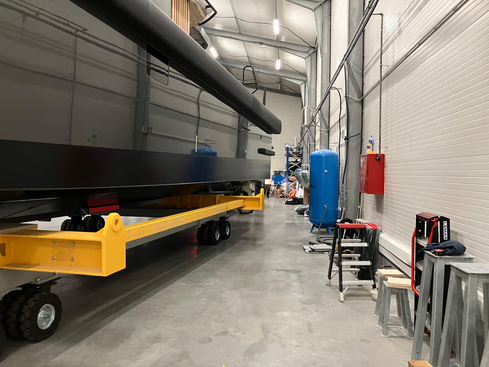 Yacht on cradle inside workshop facility